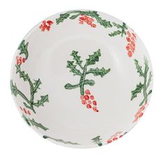 a white bowl with holly and red berries on it