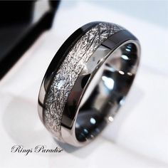 a wedding ring that has been made to look like it is covered in silver and black