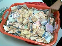 a red tray filled with lots of money