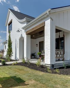 a white house with an attached porch and covered patio