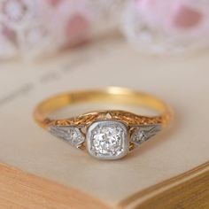 a close up of a ring on top of a book