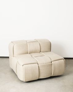 a white couch sitting on top of a cement floor