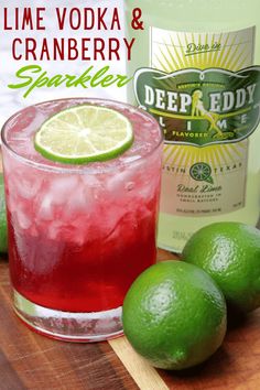 lime vodka and cranberry sparkler cocktail on a cutting board with limes