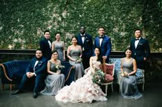 a group of people in formal wear posing for a photo