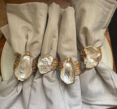 Napkin Rings: choice of gold wire or coastal rope. $40/4 rings  $20/2 rings Oyster Shell Napkin Rings, Shell Napkin Rings, Art Coquillage, Oyster Shell Crafts, Woven Ring, Wedding Table Decor, Oyster Shells, Seashell Crafts, Shell Art