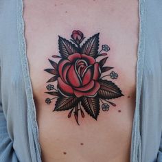 a woman with a rose tattoo on her chest