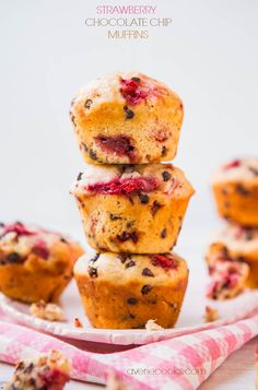 a stack of muffins sitting on top of a pink and white plate next to other muffins