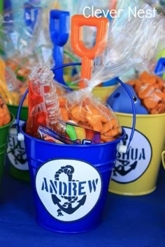 plastic buckets filled with candies on top of a table