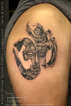 a tattoo on the back of a woman's shoulder with an image of a mask