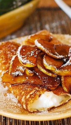 pancakes covered in powdered sugar on a plate