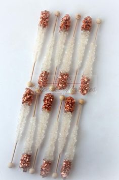 several skewers are arranged in rows on top of each other with pink and white sprinkles