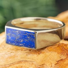 This handmade signet ring for men exudes minimalist luxury with its natural blue lapis lazuli stone and choice of gold colors. Enjoy the timeless look of this classic ring design with a colorful, nature-inspired twist! RING LAYOUTRing Width: 8mm Tapered to 5mmRing Sleeve: 14k GoldRing Profile: FlatRing Finish: Polished 0.75 mm 14k Gold6.5 mm Lapis Lazuli0.75 mm 14k Gold Signet Ring For Men, Engraved Wedding Rings, Minimalist Luxury, Blue Lapis Lazuli, Lapis Lazuli Stone, Yellow Gold Jewelry, Twist Ring, Ring For Men, White Gold Jewelry