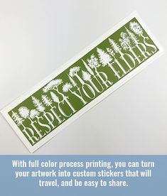 a green and white sticker with trees on it