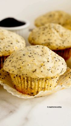 three poppy seed muffins on a plate with dipping sauce