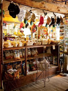 the inside of a store with lots of items hanging from it's ceiling and baskets on display