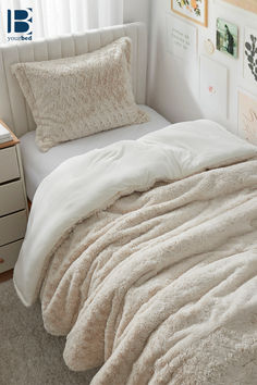 an unmade bed in a bedroom with white sheets and blankets on it's headboard