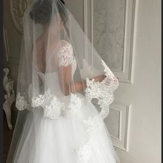 a woman wearing a wedding dress and veil