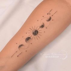 a woman's arm with the sun and moon tattoos on it