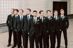 a group of men in suits standing next to each other