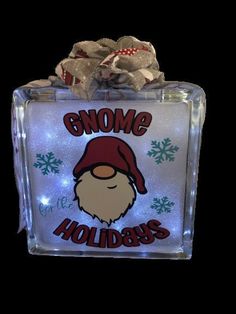 an ice block with the words gnomes on it and a santa claus's hat