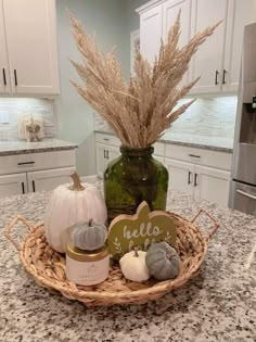 a basket filled with lots of different items on top of a kitchen counter next to a bottle