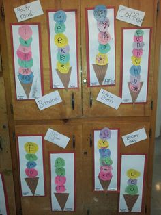 some ice cream cones with letters and numbers on them are displayed in front of a wooden door