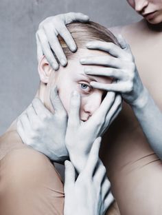 a woman covering her face with both hands