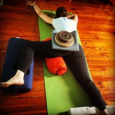 a woman laying on top of a yoga mat