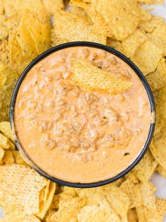 a black bowl filled with salsa and tortilla chips