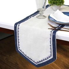 a white table topped with a blue and white place setting