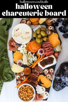 a table topped with lots of halloween food