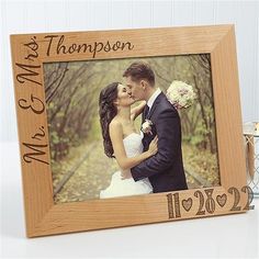 a wooden photo frame with a couple kissing