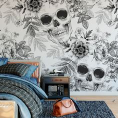 a bedroom with skulls and flowers painted on the wall