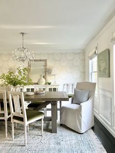 a dining room table with chairs and a chandelier