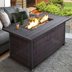 a fire pit sitting on top of a wooden table in front of a patio area