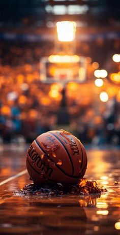 a basketball sitting on top of a wet floor