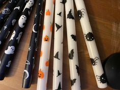 halloween candles are lined up on a table with bats, pumpkins and ghostes