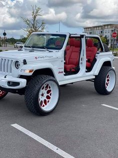 a white jeep with red leather seats parked in a parking lot