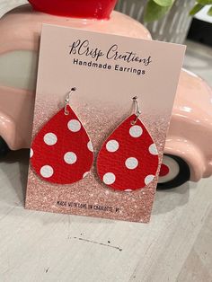 Add a playful pop of color to your style with these charming Red and White Polka Dot Earrings. Crafted from faux leather, these fun and colorful earrings feature a classic red and white polka dot pattern, making them the perfect accessory to showcase your vibrant personality and add a touch of whimsy to any outfit.  Hypoallergenic and nickel-free hooks with a clear back for a secure fit Playful Red Drop Earrings, Fun Red Adjustable Earrings, Playful Nickel-free Red Earrings, Trendy Red Earrings For Birthday, Playful Red Pierced Earrings, Playful Red Earrings For Pierced Ears, Trendy Red Teardrop Earrings, Vibrant Personality, Polka Dot Earrings