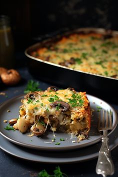 a piece of casserole on a plate with a fork next to the casserole