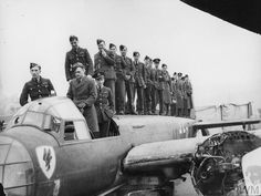 a group of men standing on top of an airplane