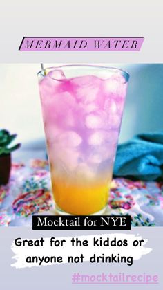 a tall glass filled with ice sitting on top of a table next to a potted plant