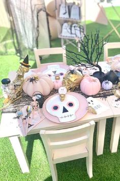 a table set up with halloween decorations and pumpkins