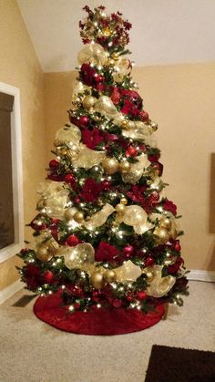 a christmas tree decorated with gold and red ornaments