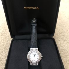 Authentic Tiffany And Co. Intaglio Ladies Watch. Silver! Comes With Original Leather Black Band. Marked Genuine Ostrich Tiffany And Co. Swiss Made. Watch Comes With Beautiful Black Vintage Velour Box. The Little Inside Piece That Holds The Watch Inside The Box Is Missing. Watch Is Quartz And Battery Was Just Recently Replaced. Has A Nice Sweep Hand And Roman Numerals. Marked Stainless, Water Resistant. Watch Is In Perfect Working Order! See Pics For Full Description. Any Questions, Please Ask Eagles Hoodie, Water Resistant Watch, Watches Women Leather, Pullover Windbreaker, Tiffany And Co, Black Vintage, Ladies Watch, Stainless Steel Watch, Roman Numerals