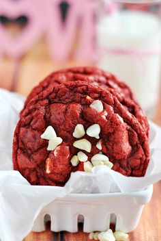 a red cookie with white chocolate chips in it