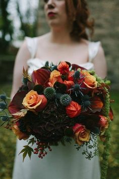 a woman holding a bouquet of flowers in her hands