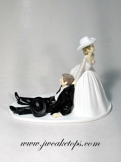 a figurine of a bride and groom laying down