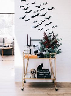 a living room filled with lots of halloween decorations and bats on the wall above it