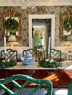 the dining room is decorated for christmas with green chairs